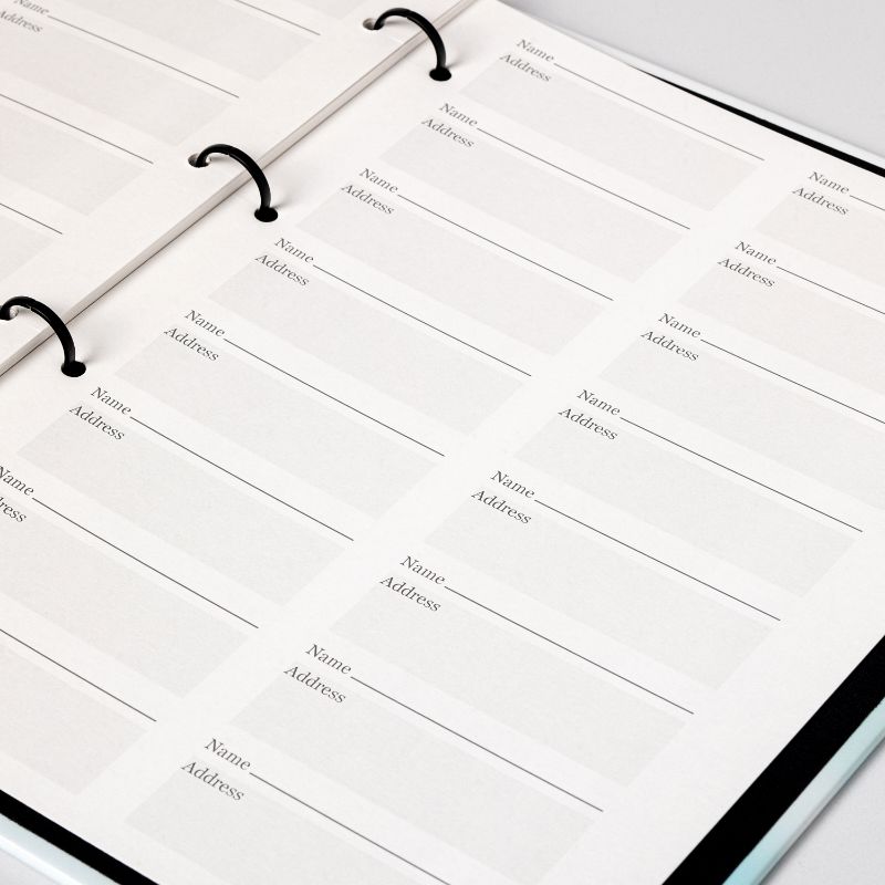 Guest register pages inside a memorial registration binder, ruled in blocks for each guest name and address